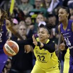 Seattle Storm's Alysha Clark (32) reaches for a loose ball in front of Phoenix Mercury's DeWanna Bonner (24) and Brittney Griner (42) during the second half of Game 1 of a WNBA basketball playoff semifinal Sunday, Aug. 26, 2018, in Seattle. The Storm won 91-87. (AP Photo/Elaine Thompson)
