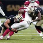 New Orleans Saints quarterback Taysom Hill (7) and wide receiver Ted Ginn (19) tackle Arizona Cardinals linebacker Haason Reddick (43) after an interception during the first half of an NFL preseason football game in New Orleans, Friday, Aug. 17, 2018. (AP Photo/Gerald Herbert)