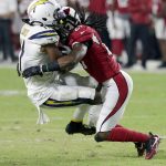 Arizona Cardinals defensive back Travell Dixon, right, hits Los Angeles Chargers wide receiver Geremy Davis (11) during the second half of a preseason NFL football game, Saturday, Aug. 11, 2018, in Glendale, Ariz. (AP Photo/Rick Scuteri)