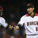 Arizona Diamondbacks relief pitcher Yoshihisa Hirano (66) shakes hands with catcher Alex Avila, left, after the final out of a baseball game against the Los Angeles Angels on Wednesday, Aug. 22, 2018, in Phoenix. The Diamondbacks defeated the Angels 5-1. (AP Photo/Ross D. Franklin)