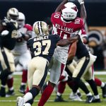 Arizona Cardinals wide receiver Chad Williams (10) pulls in a pass as New Orleans Saints cornerback Arthur Maulet (37) covers in the first half of an NFL preseason football game in New Orleans, Friday, Aug. 17, 2018. (AP Photo/Butch Dill)