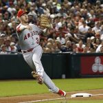 Los Angeles Angels third baseman Taylor Ward makes an off-balance throw to first base in a vain attempt to get Arizona Diamondbacks Daniel Descalso on an infield hit during the fourth inning of a baseball game Wednesday, Aug. 22, 2018, in Phoenix. (AP Photo/Ross D. Franklin)