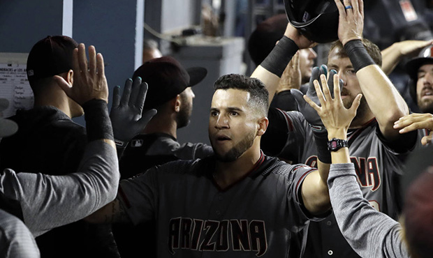Arizona Diamondbacks' David Peralta, center, celebrates his three-run home run with teammates in th...