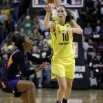 Seattle Storm's Sue Bird (10) passes the ball in front of Phoenix Mercury's Briann January during the second half of Game 1 of a WNBA basketball playoff semifinal Sunday, Aug. 26, 2018, in Seattle. The Storm won 91-87. (AP Photo/Elaine Thompson)