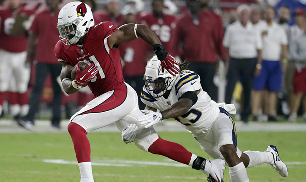 Arizona Cardinals running back David Johnson (31) is tripped up by Los Angeles Chargers defensive b...