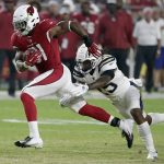 Arizona Cardinals running back David Johnson (31) is tripped up by Los Angeles Chargers defensive back Rayshawn Jenkins (25) during the first half of a preseason NFL football game, Saturday, Aug. 11, 2018, in Glendale, Ariz. (AP Photo/Rick Scuteri)