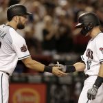 Arizona Diamondbacks' Nick Ahmed, right, celebrates with Steven Souza Jr. (28) after hitting a two-run home run against the San Francisco Giants in the fifth inning during a baseball game, Saturday, Aug. 4, 2018, in Phoenix. (AP Photo/Rick Scuteri)
