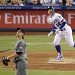 Los Angeles Dodgers' Enrique Hernandez runs to first after hitting a solo home run off Arizona Diamondbacks starting pitcher Zack Greinke, left, during the seventh inning of a baseball game Friday, Aug. 31, 2018, in Los Angeles. (AP Photo/Mark J. Terrill)