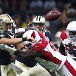 New Orleans Saints quarterback Taysom Hill (7) passes under pressure from Arizona Cardinals defensive tackle Rodney Gunter in the first half of an NFL preseason football game in New Orleans, Friday, Aug. 17, 2018. (AP Photo/Butch Dill)