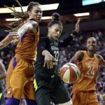 Seattle Storm's Alysha Clark (32) reaches for a loose ball between Phoenix Mercury's Brittney Griner, left, and DeWanna Bonner in the second half in a WNBA basketball playoff semifinal, Tuesday, Aug. 28, 2018, in Seattle. The Storm won 91-87 in overtime. (AP Photo/Elaine Thompson)