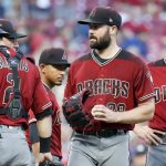 Arizona Diamondbacks starting pitcher Robbie Ray, second from right, meets with teammates on the mound in the first inning of a baseball game against the Cincinnati Reds, Saturday, Aug. 11, 2018, in Cincinnati. (AP Photo/John Minchillo)