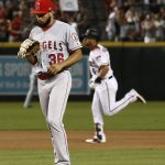 Los Angeles Angels pitcher Williams Jerez (36) pauses on the mound after giving up a two-run home run to Arizona Diamondbacks' David Peralta, rear, during the seventh inning of a baseball game Wednesday, Aug. 22, 2018, in Phoenix. The Diamondbacks defeated the Angels 5-1. (AP Photo/Ross D. Franklin)