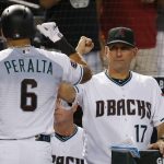 Arizona Diamondbacks' David Peralta (6) celebrates his two-run home run against the Los Angeles Angels with manager Torey Lovullo (17) during the first inning of a baseball game, Tuesday, Aug. 21, 2018, in Phoenix. (AP Photo/Ross D. Franklin)