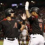 Arizona Diamondbacks' David Peralta, left, celebrates with Ketel Marte (4) after scoring during the first inning of a baseball game against the San Francisco Giants on Friday, Aug. 3, 2018, in Phoenix. (AP Photo/Ross D. Franklin)
