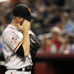 San Francisco Giants starting pitcher Chris Stratton wipes his face after giving up a two-run single to Arizona Diamondbacks' Patrick Corbin during the first inning of a baseball game Friday, Aug. 3, 2018, in Phoenix. (AP Photo/Ross D. Franklin)