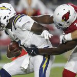 Los Angeles Chargers quarterback Cardale Jones (7) is sacked by Arizona Cardinals defensive tackle Olsen Pierre (72) during the first half of a preseason NFL football game, Saturday, Aug. 11, 2018, in Glendale, Ariz. (AP Photo/Ross D. Franklin)