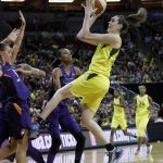 Seattle Storm's Breanna Stewart, right, gets off a shot against the Phoenix Mercury late in the second half of Game 1 of a WNBA basketball playoff semifinal Sunday, Aug. 26, 2018, in Seattle. Stewart led all scorers with 28 points as the Storm won 91-87. (AP Photo/Elaine Thompson)