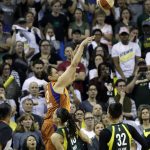 Subdued Seattle Storm fans look on as Phoenix Mercury's Diana Taurasi nails a 3-point shot with seconds left in the second half to send the game into overtime in a WNBA basketball playoff semifinal, Tuesday, Aug. 28, 2018, in Seattle. The Storm won 91-87 in overtime. (AP Photo/Elaine Thompson)