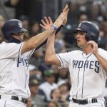 San Diego Padres' Eric Hosmer, left, and Hunter Renfroe celebrate after they score on a two-run single by Freddy Galvis during the fourth inning of a baseball game against the Arizona Diamondbacks in San Diego, Saturday, Aug. 18, 2018. (AP Photo/Kyusung Gong)