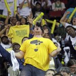 Seattle Storm fans cheer during a break against the Phoenix Mercury in the second half in a WNBA basketball playoff semifinal Tuesday, Aug. 28, 2018, in Seattle. The Storm won 91-87 in overtime. (AP Photo/Elaine Thompson)