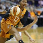 Phoenix Mercury guard Briann January (12) steals the ball from Seattle Storm guard Sue Bird, obscured at lower rear, during the first half of Game 3 of a WNBA basketball playoffs semifinal Friday, Aug. 31, 2018, in Phoenix. (AP Photo/Ross D. Franklin)