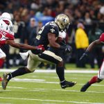 New Orleans Saints running back Mark Ingram (22) carries between Arizona Cardinals defensive back Bene' Benwikere (23) and defensive back Antoine Bethea (41) in the first half of an NFL preseason football game in New Orleans, Friday, Aug. 17, 2018. (AP Photo/Butch Dill)