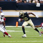 New Orleans Saints wide receiver Tre'Quan Smith (10) pulls in a pass reception between Arizona Cardinals defensive back Bene' Benwikere (23) and defensive back A.J. Howard (42) in the first half of an NFL preseason football game in New Orleans, Friday, Aug. 17, 2018. (AP Photo/Butch Dill)