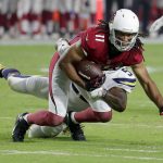 Arizona Cardinals wide receiver Larry Fitzgerald (11) is tackled by Los Angeles Chargers linebacker Jatavis Brown during the first half of a preseason NFL football game, Saturday, Aug. 11, 2018, in Glendale, Ariz. (AP Photo/Rick Scuteri)