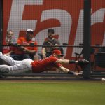 Los Angeles Angels right fielder Kole Calhoun dives in vain for a double hit by Arizona Diamondbacks' David Peralta during the fifth inning of a baseball game Tuesday, Aug. 21, 2018, in Phoenix. (AP Photo/Ross D. Franklin)