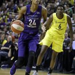Phoenix Mercury's DeWanna Bonner (24) drives past Seattle Storm's Natasha Howard during the first half of Game 1 of a WNBA basketball playoff semifinal Sunday, Aug. 26, 2018, in Seattle. (AP Photo/Elaine Thompson)