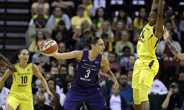 Phoenix Mercury's Diana Taurasi (3) passes the ball as Seattle Storm's Jewell Loyd, right, defends ...