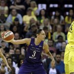 Phoenix Mercury's Diana Taurasi (3) passes the ball as Seattle Storm's Jewell Loyd, right, defends during the first half of Game 1 of a WNBA basketball playoffs semifinal Sunday, Aug. 26, 2018, in Seattle. (AP Photo/Elaine Thompson)