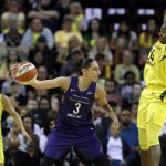 Phoenix Mercury's Diana Taurasi (3) passes the ball as Seattle Storm's Jewell Loyd, right, defends during the first half of Game 1 of a WNBA basketball playoffs semifinal Sunday, Aug. 26, 2018, in Seattle. (AP Photo/Elaine Thompson)