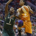 Phoenix Mercury guard Yvonne Turner, right, drives past Seattle Storm forward Crystal Langhorne (1) to score during the second half of Game 3 of a WNBA basketball playoffs semifinal Friday, Aug. 31, 2018, in Phoenix. The Mercury defeated the Storm 86-66. (AP Photo/Ross D. Franklin)