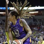 Phoenix Mercury's Brittney Griner (42) turns toward the basket as Seattle Storm's Natasha Howard defends in the first half of a WNBA basketball playoff semifinal Sunday, Aug. 26, 2018, in Seattle. (AP Photo/Elaine Thompson)