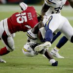 Los Angeles Chargers defensive back Brandon Facyson (36) is hit by Arizona Cardinals wide receiver Rashad Ross (15) after an interception during the second half of a preseason NFL football game, Saturday, Aug. 11, 2018, in Glendale, Ariz. (AP Photo/Ross D. Franklin)
