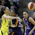 Seattle Storm's Sue Bird, left, passes as Phoenix Mercury's Briann January (12) and Diana Taurasi (3) defend in the first half of a WNBA basketball playoff semifinal Sunday, Aug. 26, 2018, in Seattle. (AP Photo/Elaine Thompson)