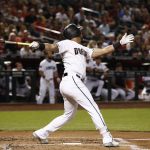 Arizona Diamondbacks' David Peralta watches the flight of his two-run home run against the Los Angeles Angels during the first inning of a baseball game Tuesday, Aug. 21, 2018, in Phoenix. (AP Photo/Ross D. Franklin)