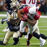 Arizona Cardinals running back D.J. Foster (37) carries as he is tackled by New Orleans Saints linebacker Alex Anzalone and linebacker A.J. Klein in the first half of an NFL preseason football game in New Orleans, Friday, Aug. 17, 2018. (AP Photo/Butch Dill)