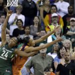 Seattle Storm's Jewell Loyd (24) gets tangled with Phoenix Mercury's DeWanna Bonner in overtime of a WNBA basketball playoff semifinal, Tuesday, Aug. 28, 2018, in Seattle. The Storm won 91-87 in overtime. (AP Photo/Elaine Thompson)