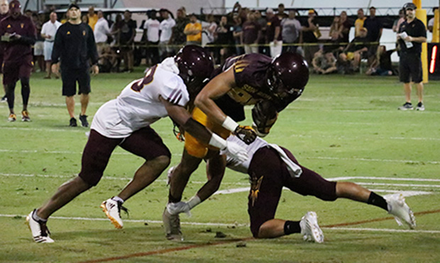 Arizona State defenders swarm to the ball during the team’s first scrimmage of the season Saturda...
