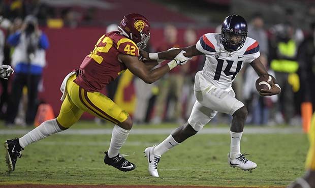Arizona quarterback Khalil Tate, right, tries to escape a tackle by Southern California linebacker ...