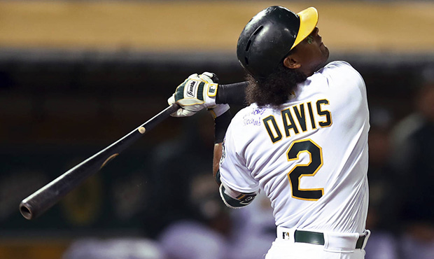 Oakland Athletics' Khris Davis swings on a pitch from Texas Rangers' Bartolo Colon in the fifth inn...