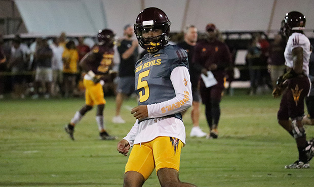 Arizona State quarterback Manny Wilkins looks to the sideline after getting by defenders during the...