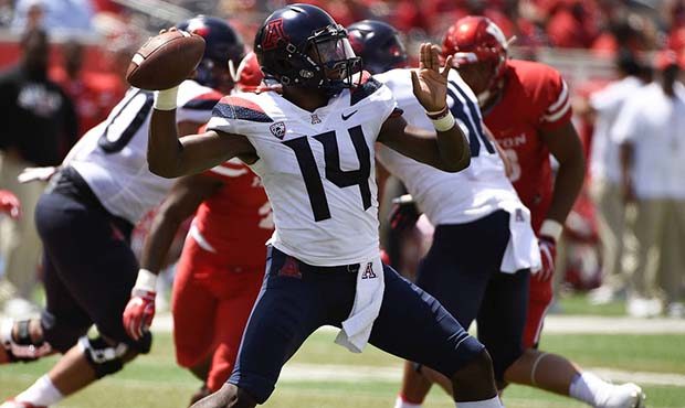 Arizona quarterback Khalil Tate (14) drops back to pass during the second half of an NCAA college f...