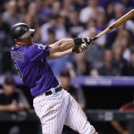 Colorado Rockies' DJ LeMahieu follows through with his swing after connecting for a two-run, walkoff home run off Arizona Diamondbacks relief pitcher Yoshihisa Hirano in the ninth inning of a baseball game Wednesday, Sept. 12, 2018, in Denver. The Rockies won 5-4. (AP Photo/David Zalubowski)