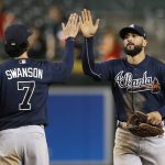 Atlanta Braves' Nick Markakis, right, gets a high-five from Dansby Swanson (7) after the final out in the 10th inning of a baseball game against the Arizona Diamondbacks Thursday, Sept. 6, 2018, in Phoenix. The Braves defeated the Diamondbacks 7-6. (AP Photo/Ross D. Franklin)