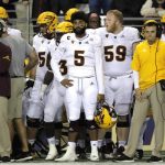 Arizona State quarterback Manny Wilkins (5) stands with teammates and coaches on the sideline during the fourth quarter of an NCAA college football game against Washington, Saturday, Sept. 22, 2018, in Seattle. Washington won 27-20. (AP Photo/Ted S. Warren)