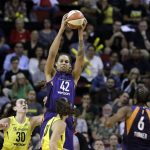 Phoenix Mercury's Brittney Griner (42) leaps to grab a pass to her during the first half of Game 5 of the team's WNBA basketball playoffs semifinal against the Seattle Storm, Tuesday, Sept. 4, 2018, in Seattle. (AP Photo/Elaine Thompson)