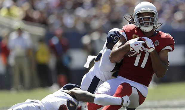 Arizona Cardinals wide receiver Larry Fitzgerald, right, is tackled by Los Angeles Rams defensive b...